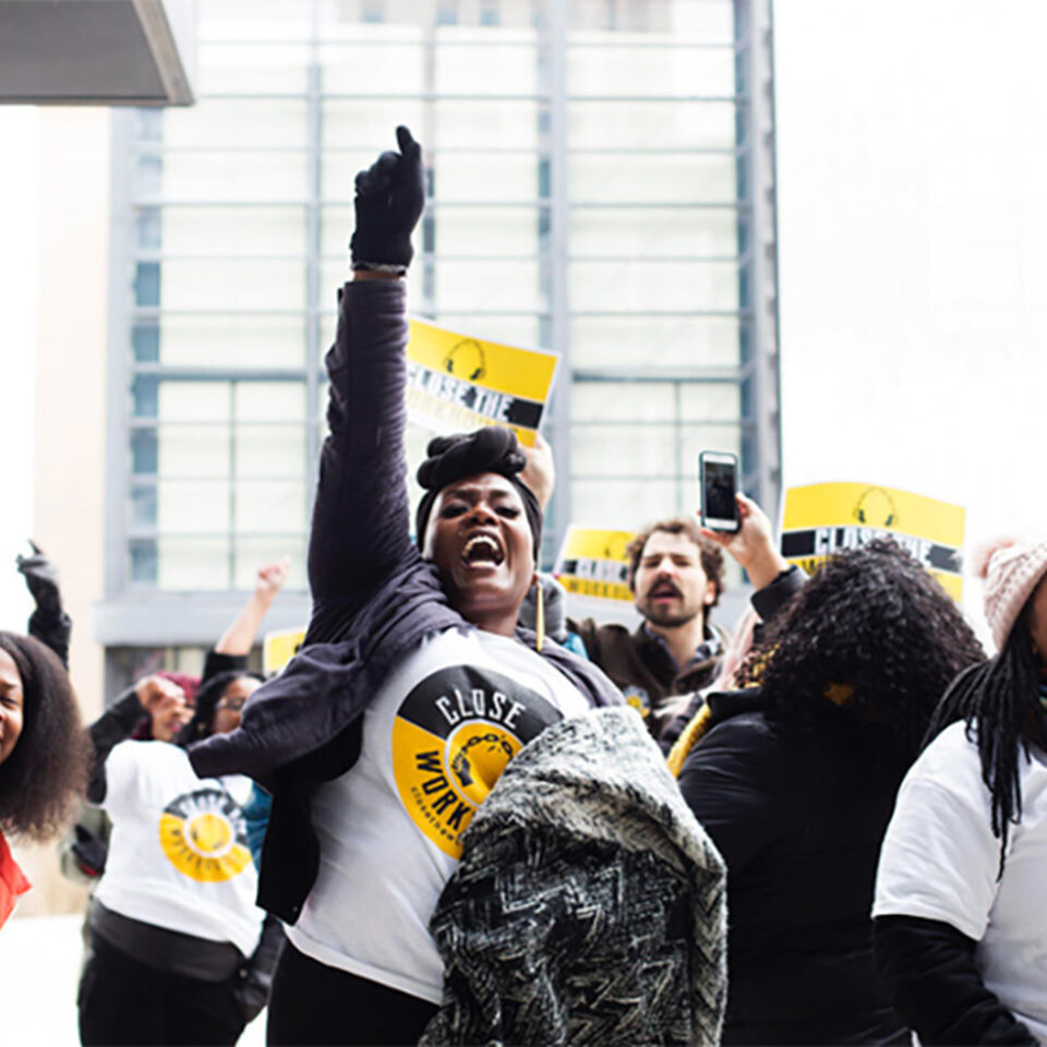 Black woman with right hand in the air
